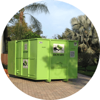Green waste junk hauling franchise container located outdoors.